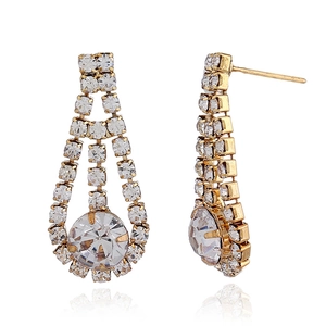 Detailed close-up of golden tassel earrings featuring sparkling white rhinestones