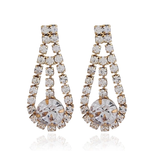 Detail view of long tassel earrings with sparkling white crystals and gold plating