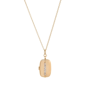 Macro view of gold plated rectangular pendant set with five sparkling clear crystals