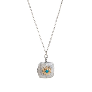 Vintage silver locket necklace with gold sunburst and turquoise bead on white background