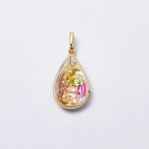 Detail of teardrop gold locket with elephant design and colorful gemstone inlay