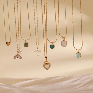 Collection of gold titanium steel necklaces with heart, pearl, and gemstone pendants