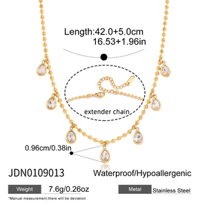 Gold stainless steel beaded necklace featuring seven sparkling teardrop crystal pendants