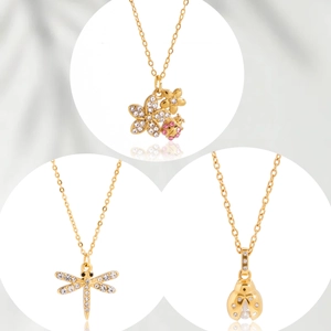 Elegant gold necklaces featuring ladybug and dragonfly pendants with sparkling cubic zirconia