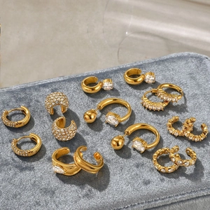 Macro shot of gold-plated stainless steel earring set with zircon in velvet box