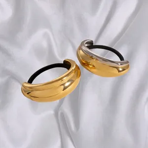 U-shaped polished metal hair ties in gold and silver finish on white satin