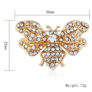 Detailed macro view of bee brooch with dimensions 38mm x 25mm and white rhinestones