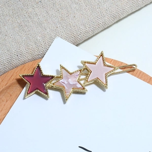 Star-shaped acrylic hair clips in gold finish with marble texture and burgundy star charms
