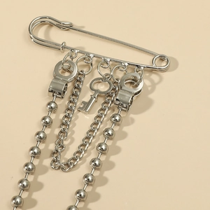 Retro punk style silver safety pin brooch with hanging metal chains and vintage key charm