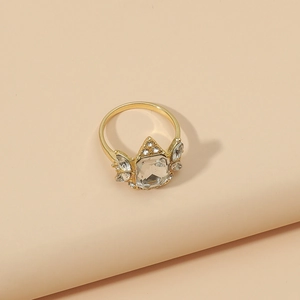 Gold geometric ring with a large rectangular crystal and sparkling rhinestone wings