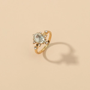 Elegant gold celestial ring with a large pear-shaped zircon and sparkling star accents