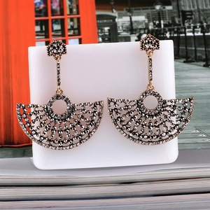 Detailed view of fan-shaped drop earrings with dark grey crystals in bohemian style