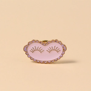 Cute pink enamel cloud pin with golden eyelashes and wavy edge for backpacks
