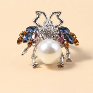 Elegant beetle brooch with white pearl, sparkling crystals and colorful gemstones in silver