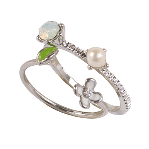 Detail of silver floral ring with opal stone, white pearl, and green enamel leaf design