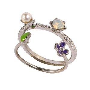 Detail of silver double-layer ring with pearl, green leaf and purple flower enamel