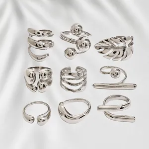 Set of minimalist geometric silver stainless steel rings in various artistic designs