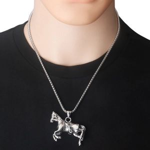 Macro detail of a silver stainless steel horse pendant on a box chain for men