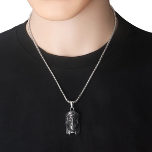 Close-up of vintage stainless steel Jesus head pendant with intricate details