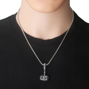 Detail of vintage Mjölnir pendant with runes on stainless steel viking necklace