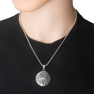 Macro view of vintage Eye of Horus pendant on square box chain with ancient engravings