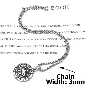 Macro detail of retro stainless steel Eye of Horus pendant with a 3mm box chain