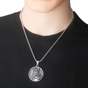 Close-up of Saint Michael vintage silver relief pendant on a classic box chain