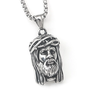 Macro detail of retro stainless steel Jesus pendant necklace with thorn crown carving