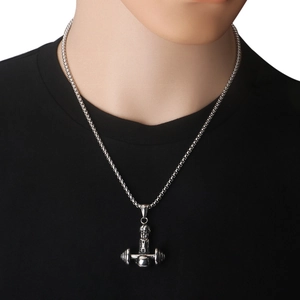 Detail view of silver dumbbell pendant necklace worn by male model on black t-shirt