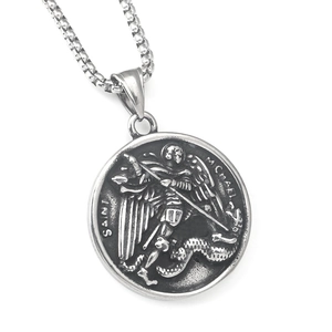 Macro detail of Saint Michael relief carving on a vintage oxidized stainless steel pendant