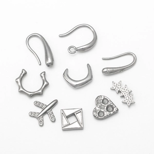 Set of stainless steel DIY jewelry parts with heart, plane and star charms on white