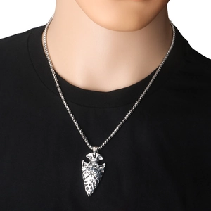 Macro detail of silver Viking spearhead pendant featuring Vegvisir symbol on a neck model