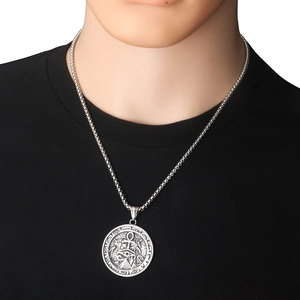 Detail of Ancient Egyptian Horus Eye and Ankh pendant on a round steel necklace