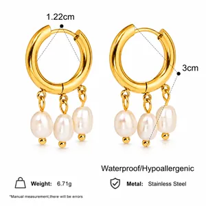 Gold plated stainless steel hoop earrings with three white pearl pendants on white background