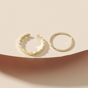 Minimalist 2-piece gold toe ring set with wavy and sleek band designs on beige display