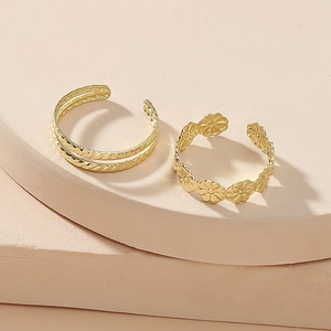 Minimalist gold geometric and daisy floral two-piece open toe ring set on display
