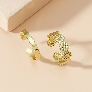 Adjustable gold ring set featuring daisy floral and wavy minimalist open band designs