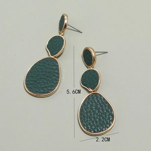 Detail view of triple-layered geometric gold earrings with green textured leather, 5.6cm long
