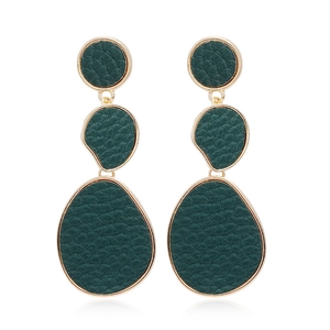 Macro detail of dark green faux leather earrings with golden metal edges in geometric shapes