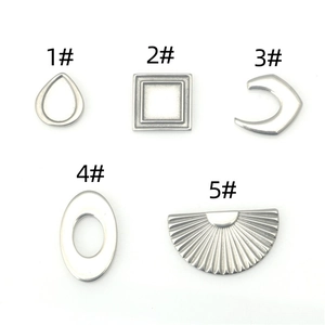 Macro detail of five assorted geometric stainless steel charms for DIY jewelry making