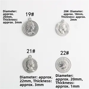 Detail of vintage silver stainless steel coin pendants showing embossed relief patterns
