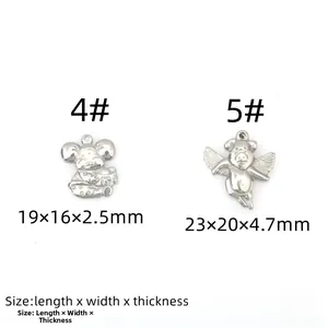 Macro detail of stainless steel mouse and flying pig charms with specific size measurements