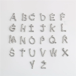 Macro shot of silver bamboo textured alphabet charms A-Z made of durable titanium steel