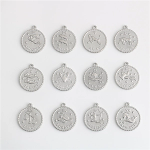 Macro shot of twelve zodiac stainless steel pendants with engraved names and beaded edges