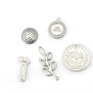 Five-piece stainless steel charm set featuring wrench leaf and coin pendants for DIY jewelry