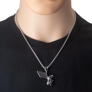 Detailed view of a stainless steel angel wing pendant worn on a silver necklace chain
