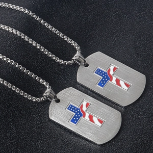 Detail of cross pendant with American flag pattern on brushed stainless steel