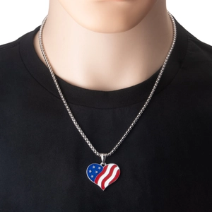 Close-up of heart-shaped USA flag enamel pendant on a fine silver stainless steel chain