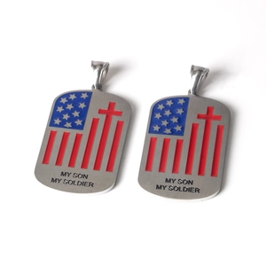 Detailed macro of stainless steel dog tag pendants with US flag cross and My Son My Soldier text
