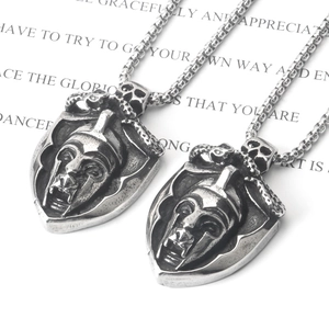 Macro detail of silver Spartan shield necklace with skull and snake engraved elements
